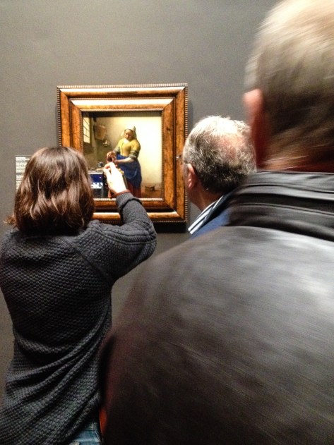 A tourist taking an iphone snap of The Milkmaid